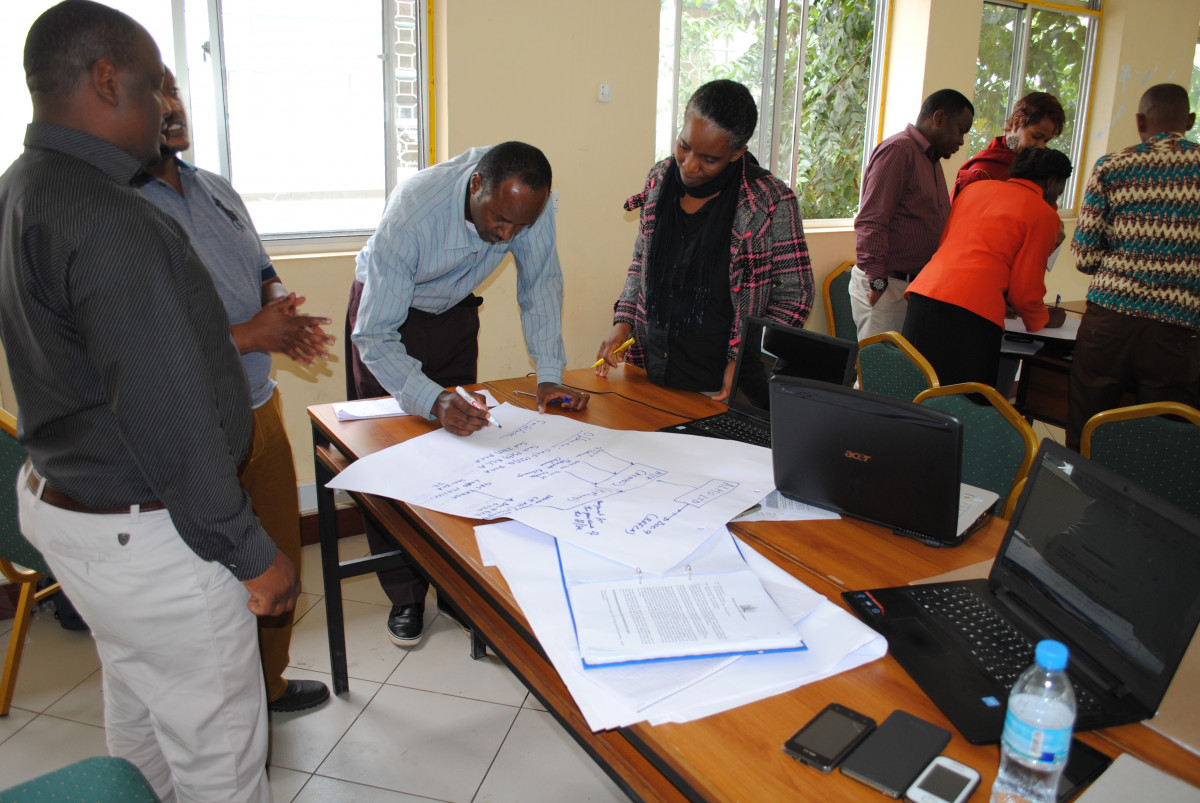 Workshop participants write on a sheet of paper