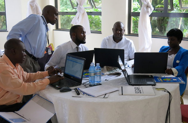 Five Ugandan trainers with computers