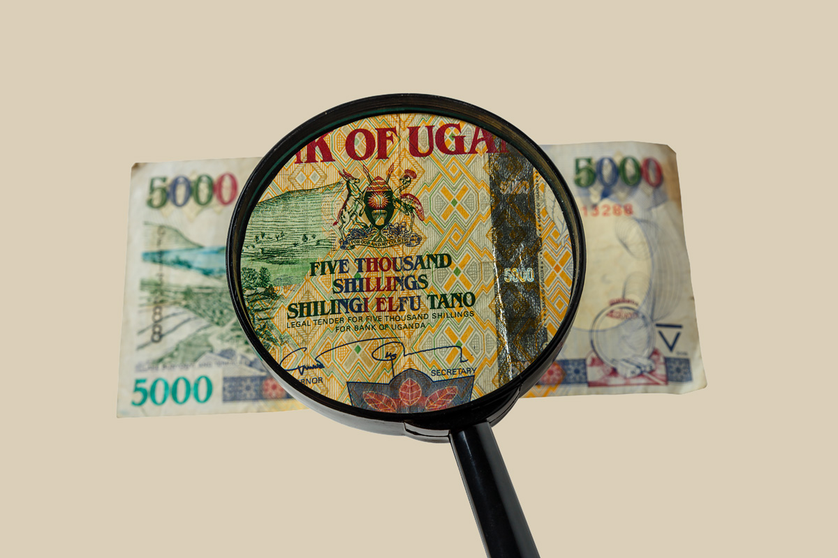 Ugandan shillings with magnifying glass