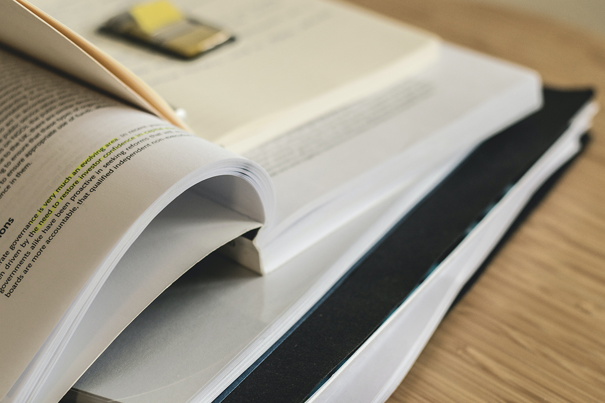 Pile of open books. Photo by Lum3n from Pexels.