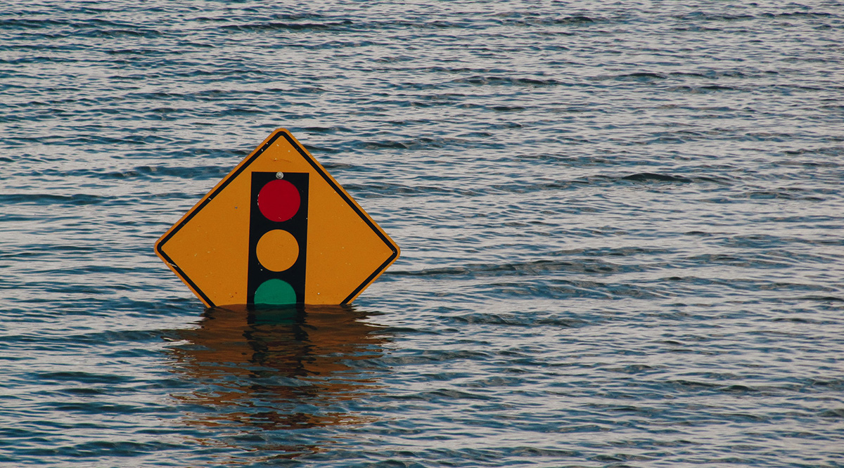 Traffic sign half covered by flood waters