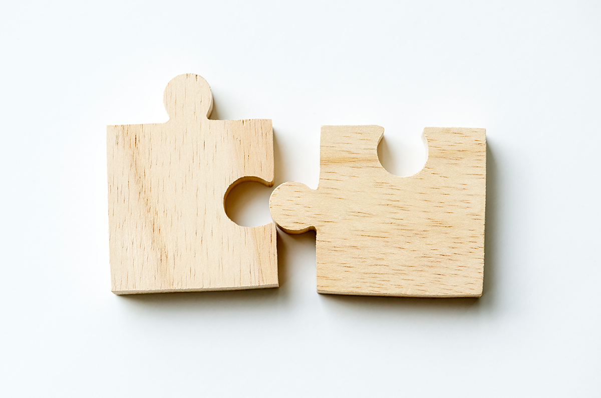Two wooden jigsaw puzzle pieces